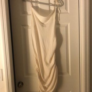Ivory sheer dress with ruching on both sides.